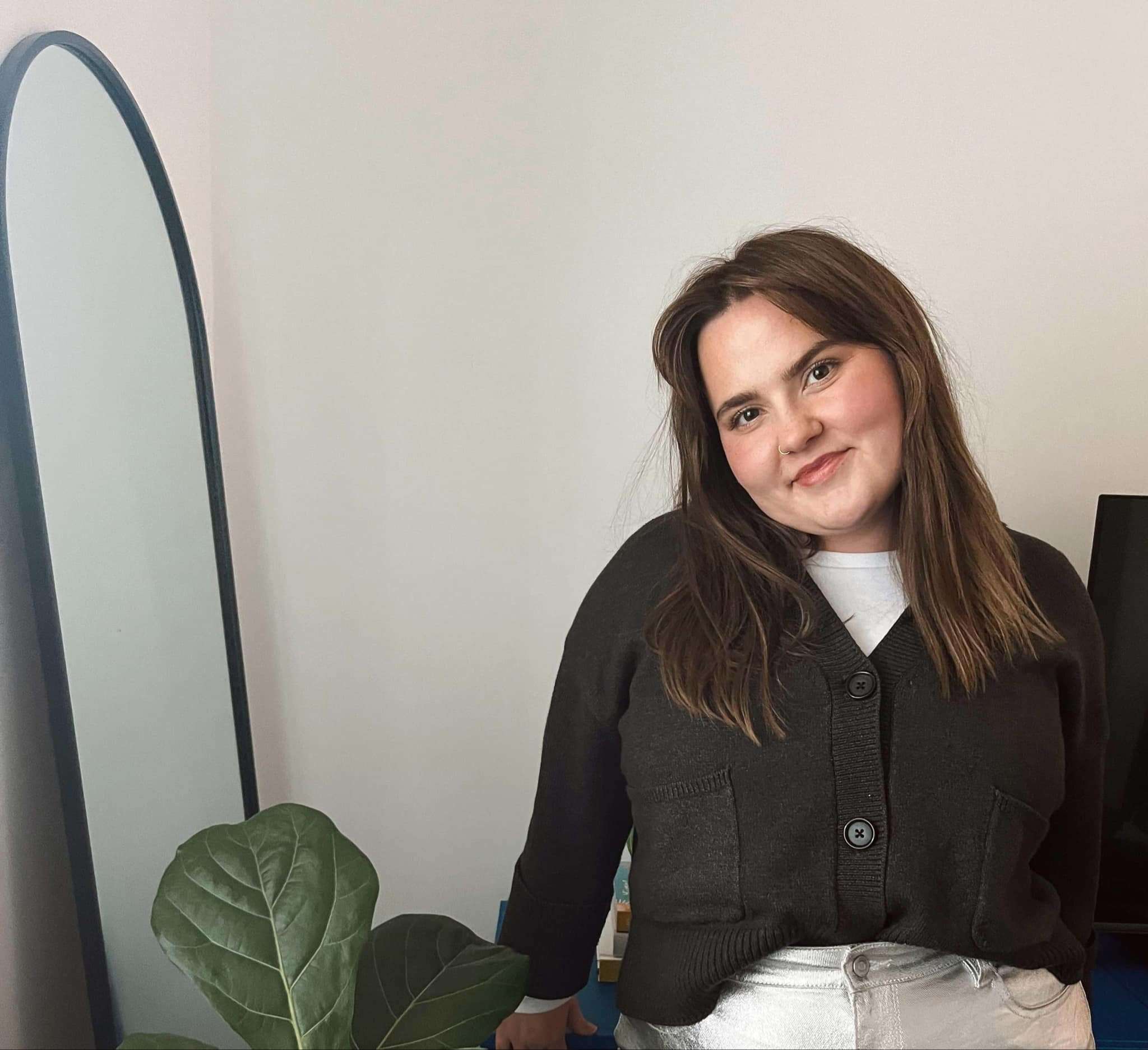 Image of Teagan, Proud Kamilaroi yinarr woman standing next to a plant and a mirror