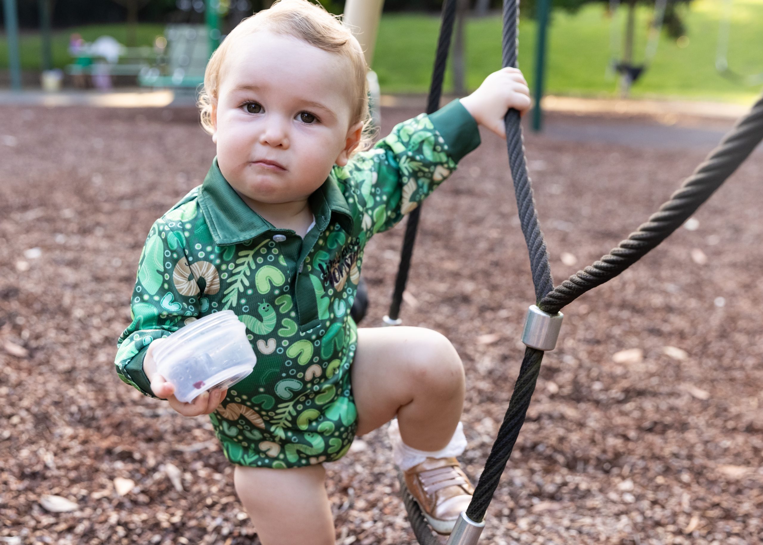 A child wearing kids fishing shirts at a playground